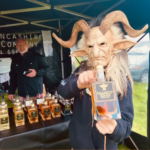 A Krampus figure holding a bottle of Krampus Spiced Mead at our stall